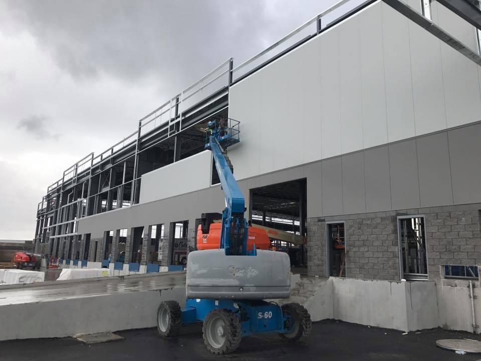 Commercial IMP panel installation — boom lift on site