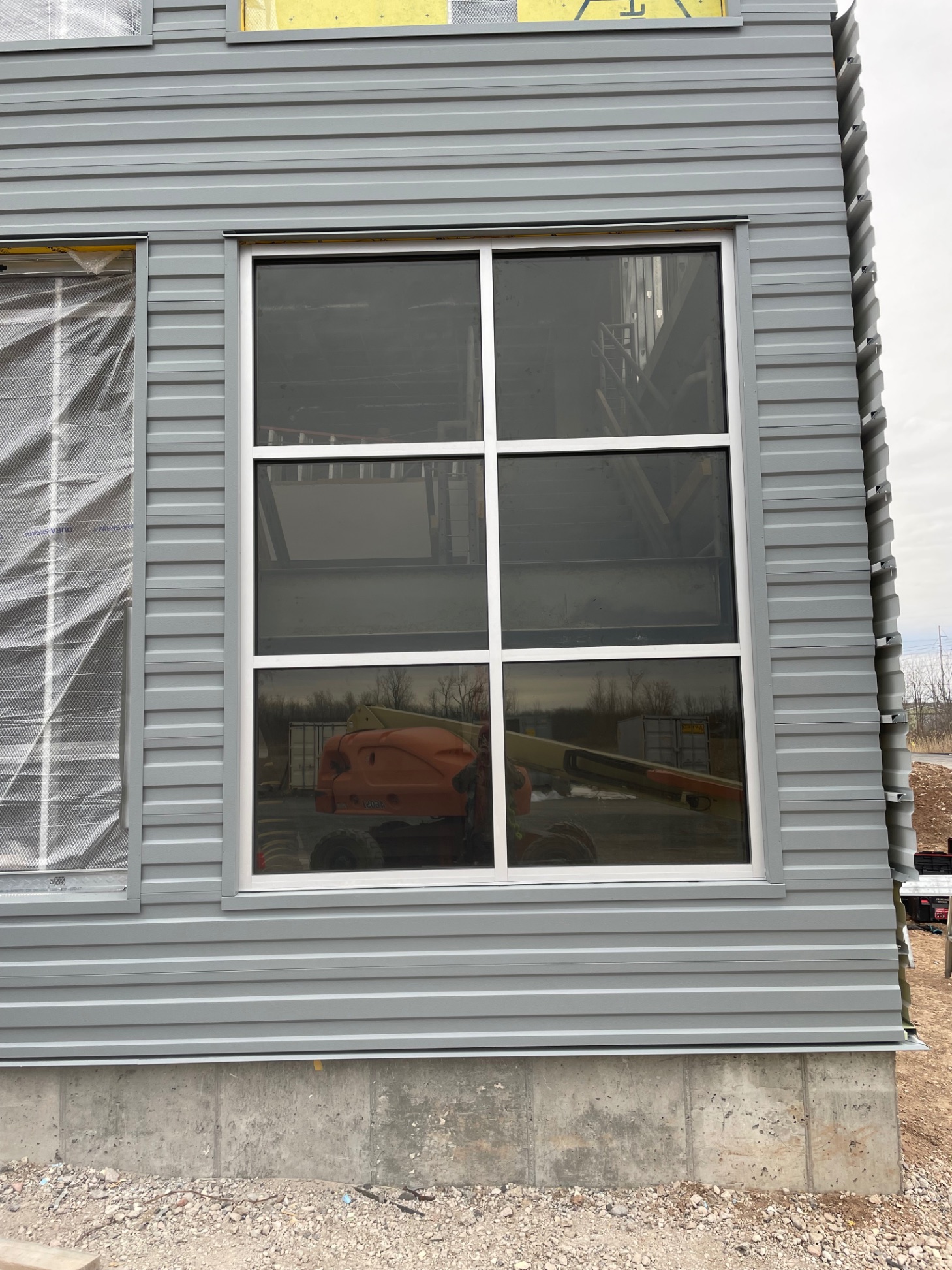 IMP panel window close-up — gray ribbed panels under construction