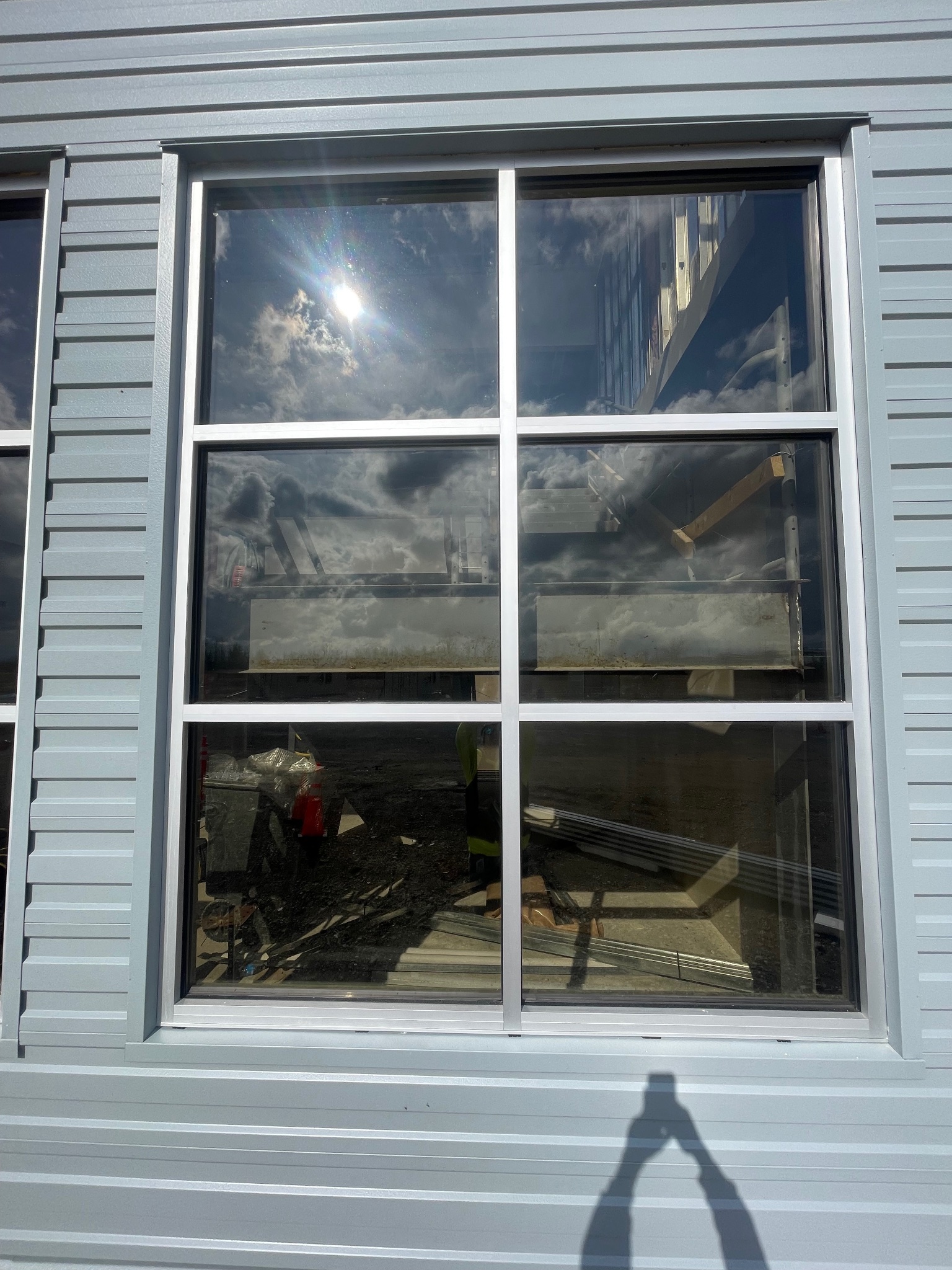 IMP panel window detail — gray metal siding with glass