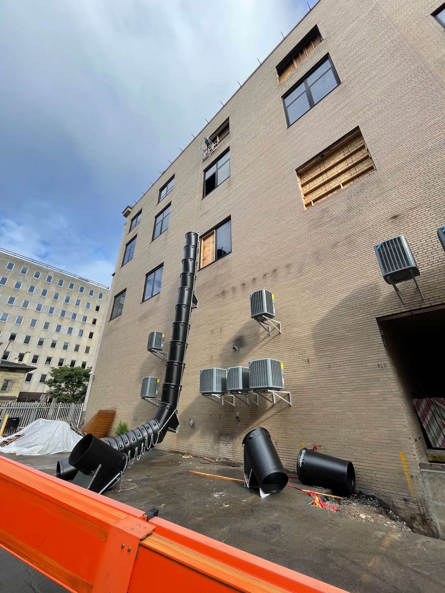 Urban renovation — multi-story brick building with debris chute