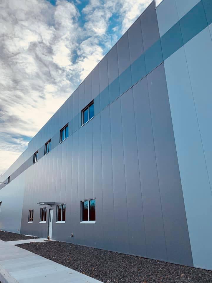 Completed commercial building — gray IMP exterior panels