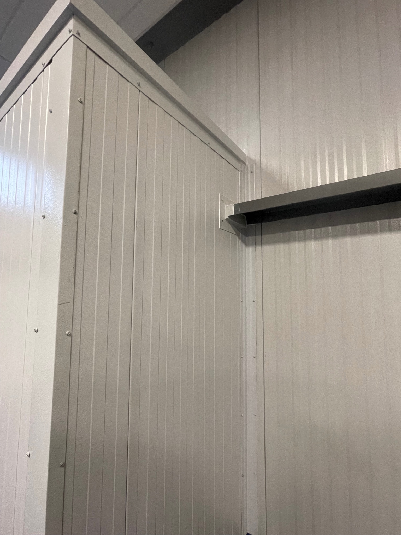 Interior IMP wall panel detail — white ribbed panels